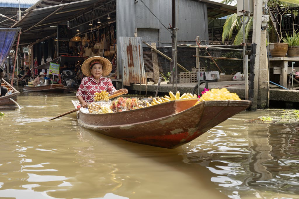 Discover the vibrant atmosphere of Bangkok's floating markets with traditional Thai produce and culture.