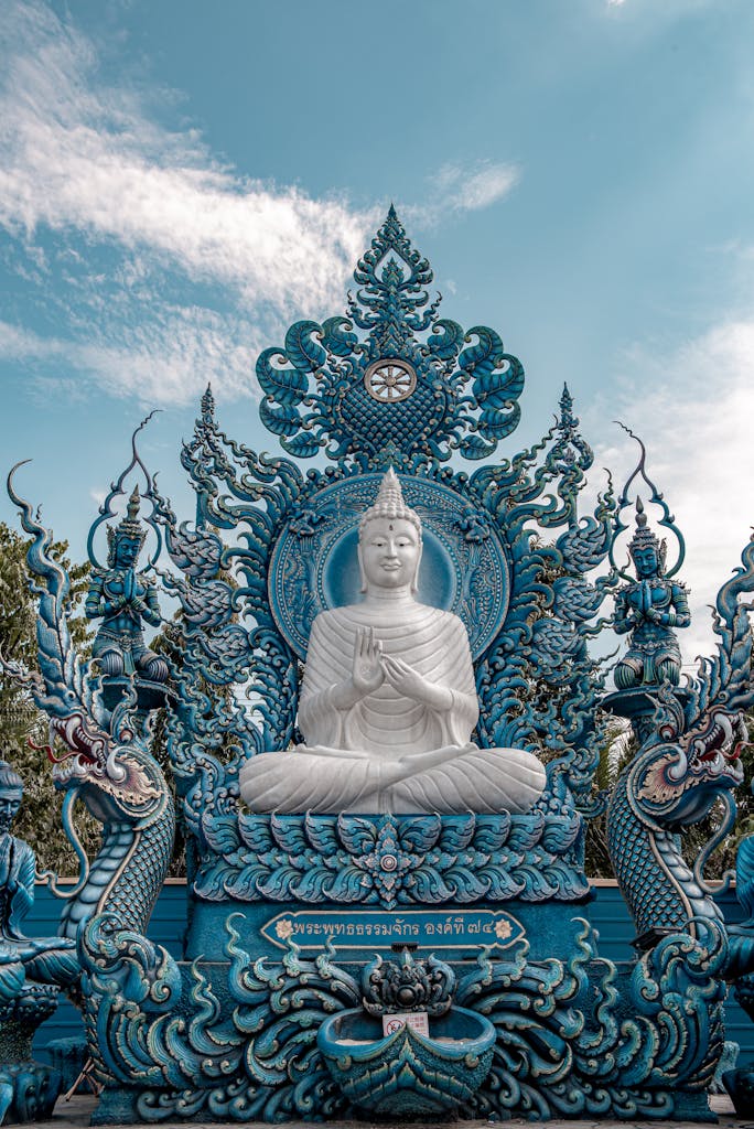 Stunning white Buddha statue at the intricate Blue Temple in Chiang Rai, Thailand.